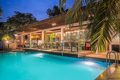 a swimming pool in front of a house at The Park New Delhi in New Delhi