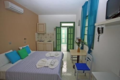 a bedroom with a bed with towels on it at Xenones Lindos in Líndos