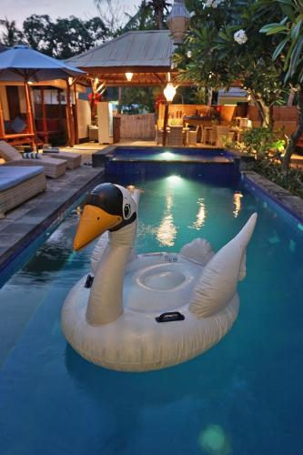 a swan float in a swimming pool at Sari Gili Bungalow in Gili Air