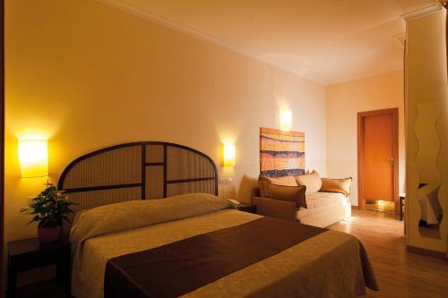 Postel nebo postele na pokoji v ubytování Hotel Novecento
