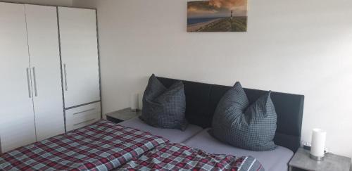 a bedroom with a bed with pillows on it at Ferienwohnung Quednau in Grafenau