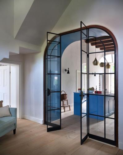 a room with a glass partition with a blue table at Bethlen Estates Transylvania in Daneş