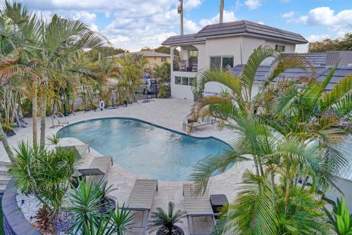 an overhead view of a swimming pool with palm trees at RA suites in Pompano Beach