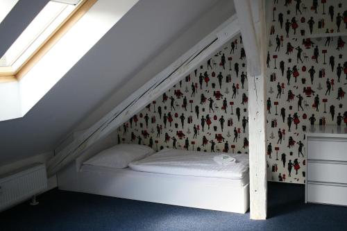 a bed in the corner of a room at ADC Design Apartmány in Brno