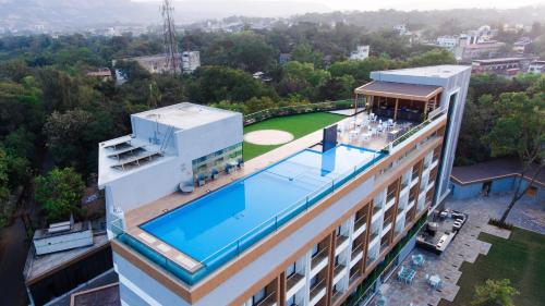 an overhead view of a building with a swimming pool at Regenta SGS Greenotel - Lonavala in Lonavala