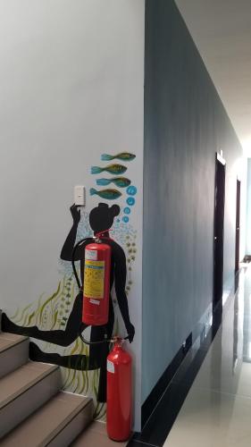 a fire hydrant next to a wall with a painting at An Nhiên Hotel in Tây Ninh
