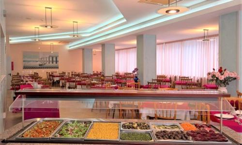 a buffet line with many different types of food at Hotel Cosmos in Rimini