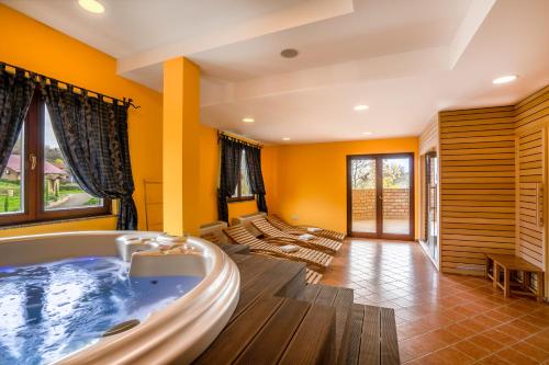 a large bathroom with a tub in a room at Stupnički Dvori Winery Hotel in Brodski Stupnik