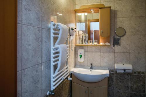 y baño con lavabo y espejo. en Hotel Narád en Mátraszentimre
