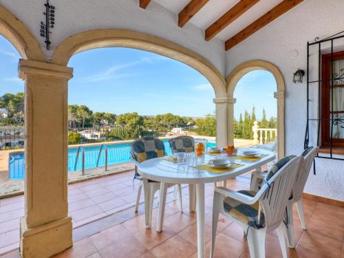 a dining room with a table and chairs on a patio at Holiday Home Cap Marti by Interhome in Balcon del Mar