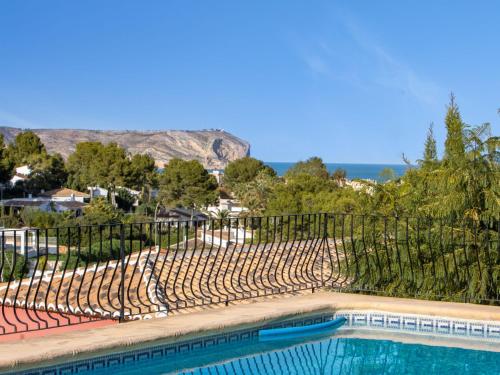 a swimming pool next to a fence with a fence at Holiday Home Cap Marti by Interhome in Balcon del Mar