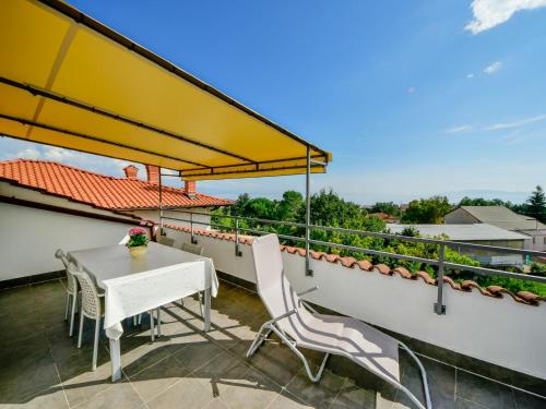a patio with a table and chairs on a balcony at Apartment Lucija by Interhome in Matulji