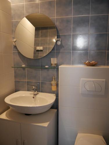 a bathroom with a sink and a mirror on the wall at Ferienhaus Bozena Appartment 1 in Vrsar