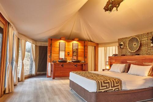 a bedroom with a large bed in a tent at Konkamoya Lodge in Ngoma