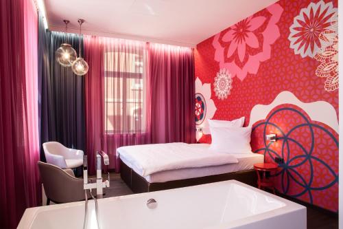a bedroom with a bed and a tub in it at Hotel & Restaurant Heyligenstaedt in Gießen
