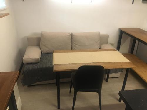 a living room with a couch and a table at Sofia Family House - Free Parking in Sofia
