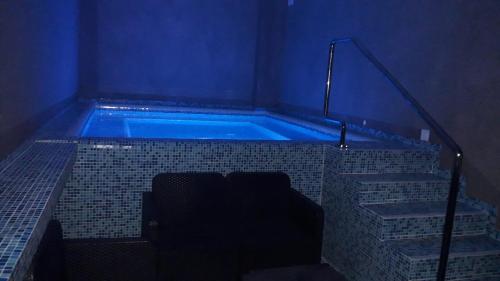 a bath tub with a blue light in a room at Hotel&SpaMontenegro Rivijera in Veles