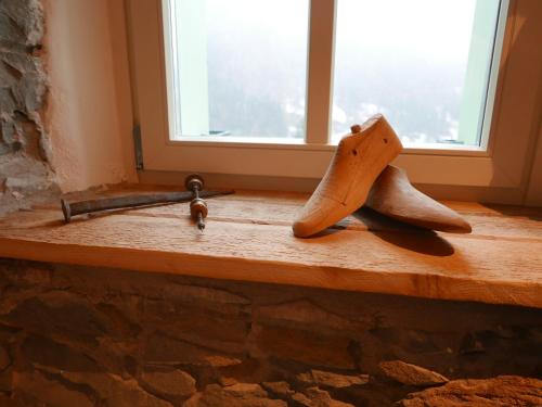 a pair of shoes sitting on a counter next to a window at La Rocia 2 in Rocca Pietore