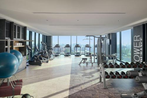 a gym with fitness equipment in a building at Holiday Inn & Suites Siracha Laemchabang by IHG in Si Racha