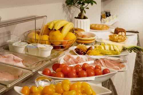 a buffet with many plates of fruits and vegetables at Relais Stibbert Florence in Florence
