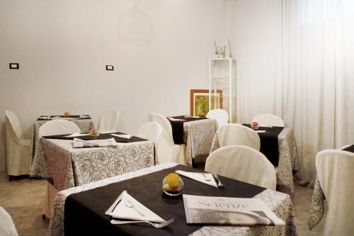 a waiting room with white chairs and tables at Relais Stibbert Florence in Florence