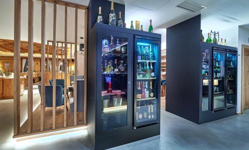 a room with several bottles of alcohol in a bar at Hotel Happy Filzmoos in Filzmoos