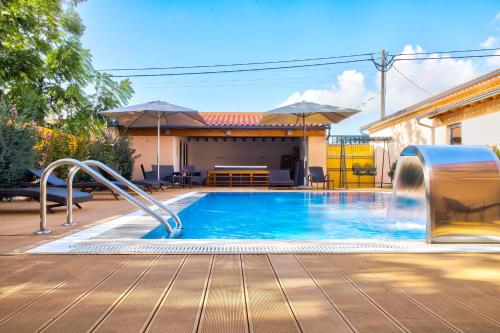 a swimming pool with a slide in a backyard at Casa da Alzira in Anadia