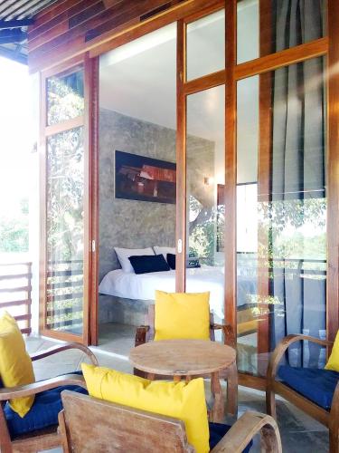 a bedroom with a bed and a table and chairs at Ping Pool Villa 2 in Mae Rim