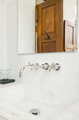 a bathroom sink with a faucet and a mirror at Ping Pool Villa 2 in Mae Rim