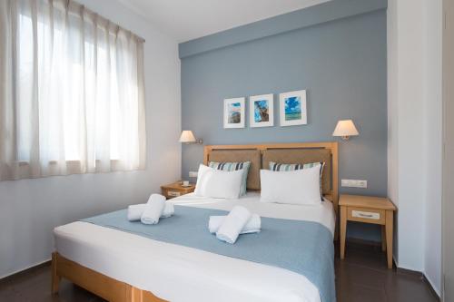 a bedroom with a large bed with two white pillows at Anna Plakias Apartments in Plakias
