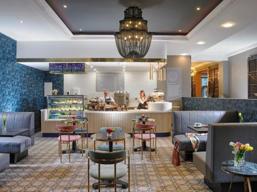 a restaurant with tables and chairs and a counter at Tullamore Court Hotel in Tullamore