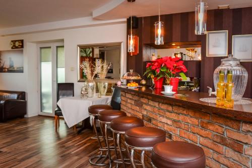 a bar with stools and a table in a restaurant at Willa Bryza in Gdynia