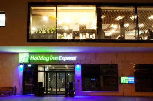 a holly inn express building at night with purple lights at Holiday Inn Express - Mülheim - Ruhr by IHG in Mülheim an der Ruhr