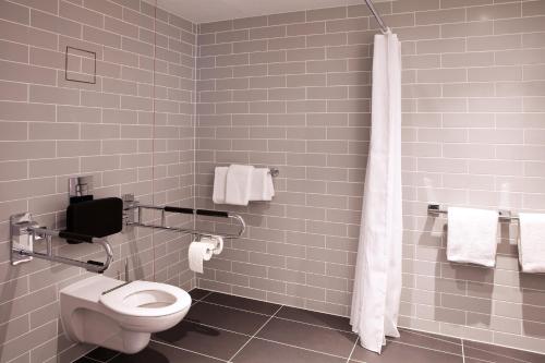a bathroom with a toilet and a shower at Holiday Inn Express - Mülheim - Ruhr by IHG in Mülheim an der Ruhr