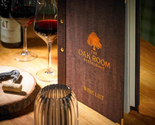 a bottle of wine and two glasses on a table at Tullamore Court Hotel in Tullamore