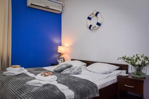 a bedroom with a bed with towels on it at Willa Bryza in Gdynia