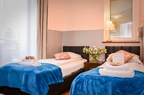 a hotel room with two beds and a laptop on them at Willa Bryza in Gdynia