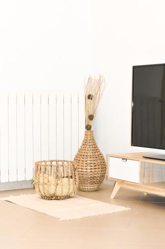 a living room with a television and a vase at Vista sul Forte in Gavi