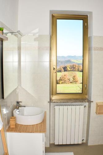 a bathroom with a sink and a window with a view at Vista sul Forte in Gavi