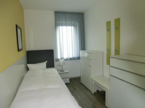 Ένα ή περισσότερα κρεβάτια σε δωμάτιο στο Kleeblatthaus Putbus Rügen