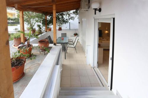 a house with a balcony with a table and chairs at Anastasia Studios Hanioti in Hanioti