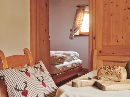 a room with a table with a loaf of bread on it at B&B Mia Majon in Canazei