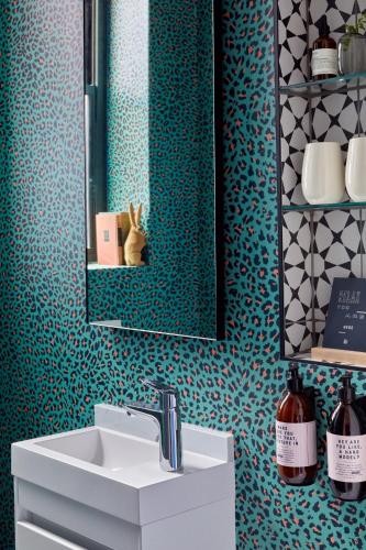 a bathroom with a sink and a mirror at Pineapple House Boutique Hotel in Cape Town