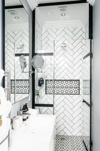a bathroom with a tub and a shower stall at Pineapple House Boutique Hotel in Cape Town