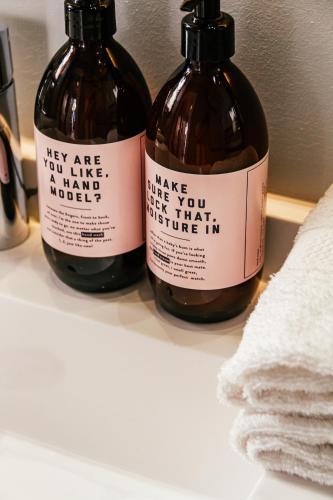 two bottles of wine sitting on top of a shelf at Pineapple House Boutique Hotel in Cape Town