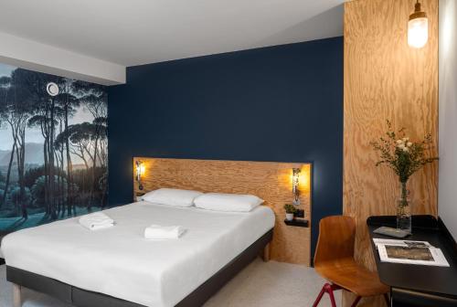Ένα ή περισσότερα κρεβάτια σε δωμάτιο στο Eklo Clermont Ferrand Centre Gare