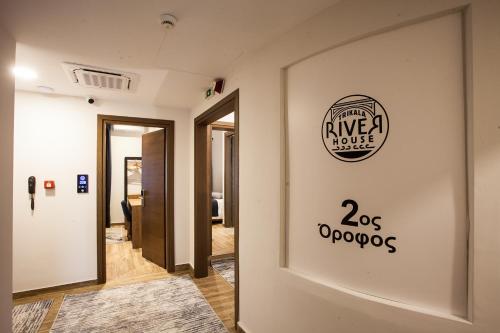 a hallway with a sign on a wall at Trikala River House in Tríkala