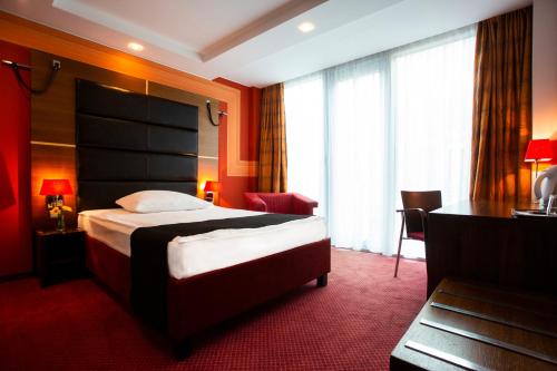 a hotel room with a bed and a large window at Art Hotel William in Bratislava