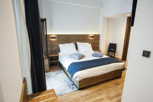 a bedroom with a large bed in a room at Trikala River House in Tríkala