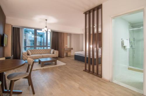 a hotel room with a bed and a table at The ONE Apart Hotel Luxury Suites & Apartments in Skopje